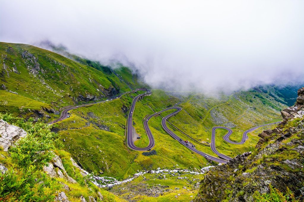 Scenic views of a highway surrounded by mountains.