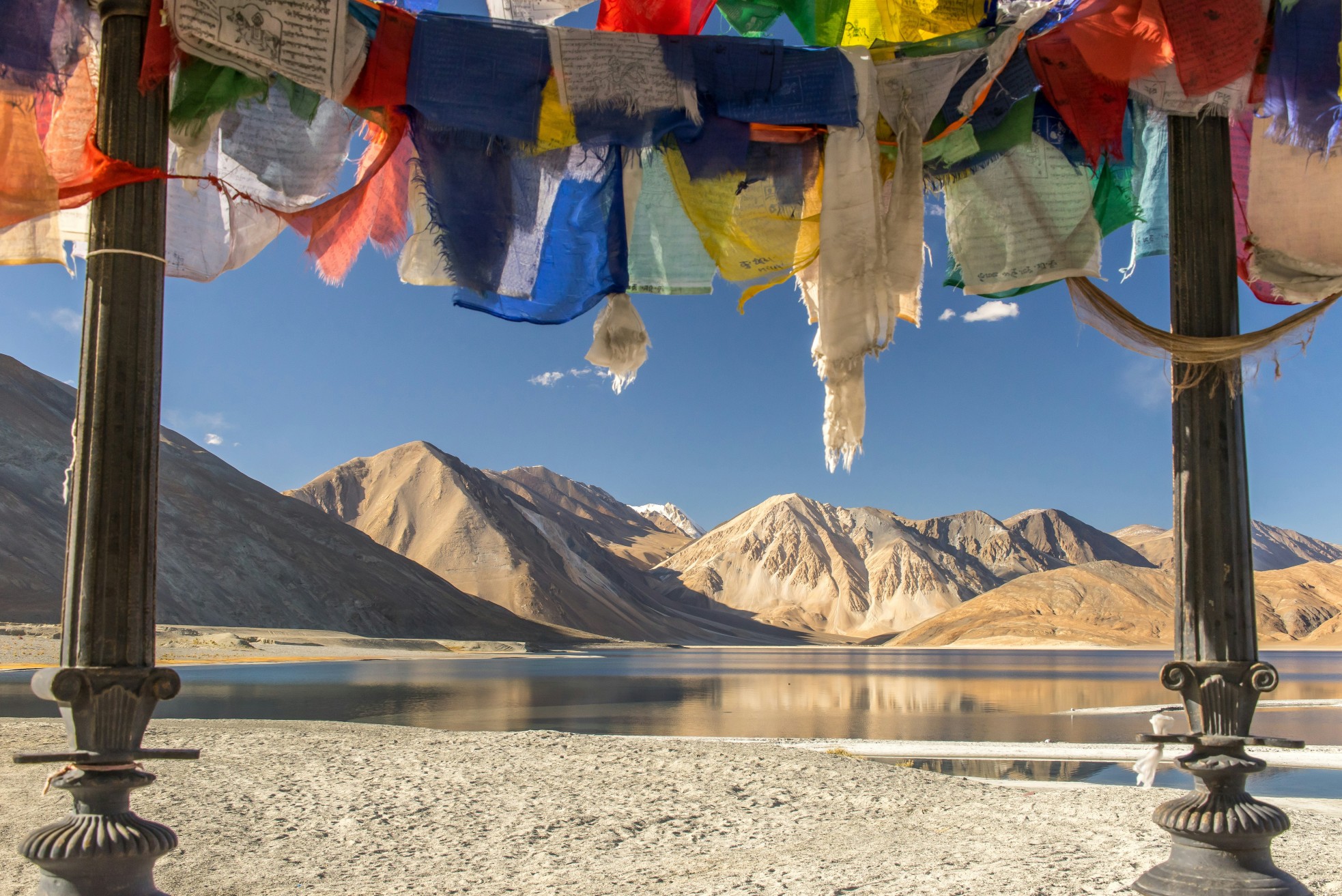 Traditional Ladakhi house with mountain backdrop.