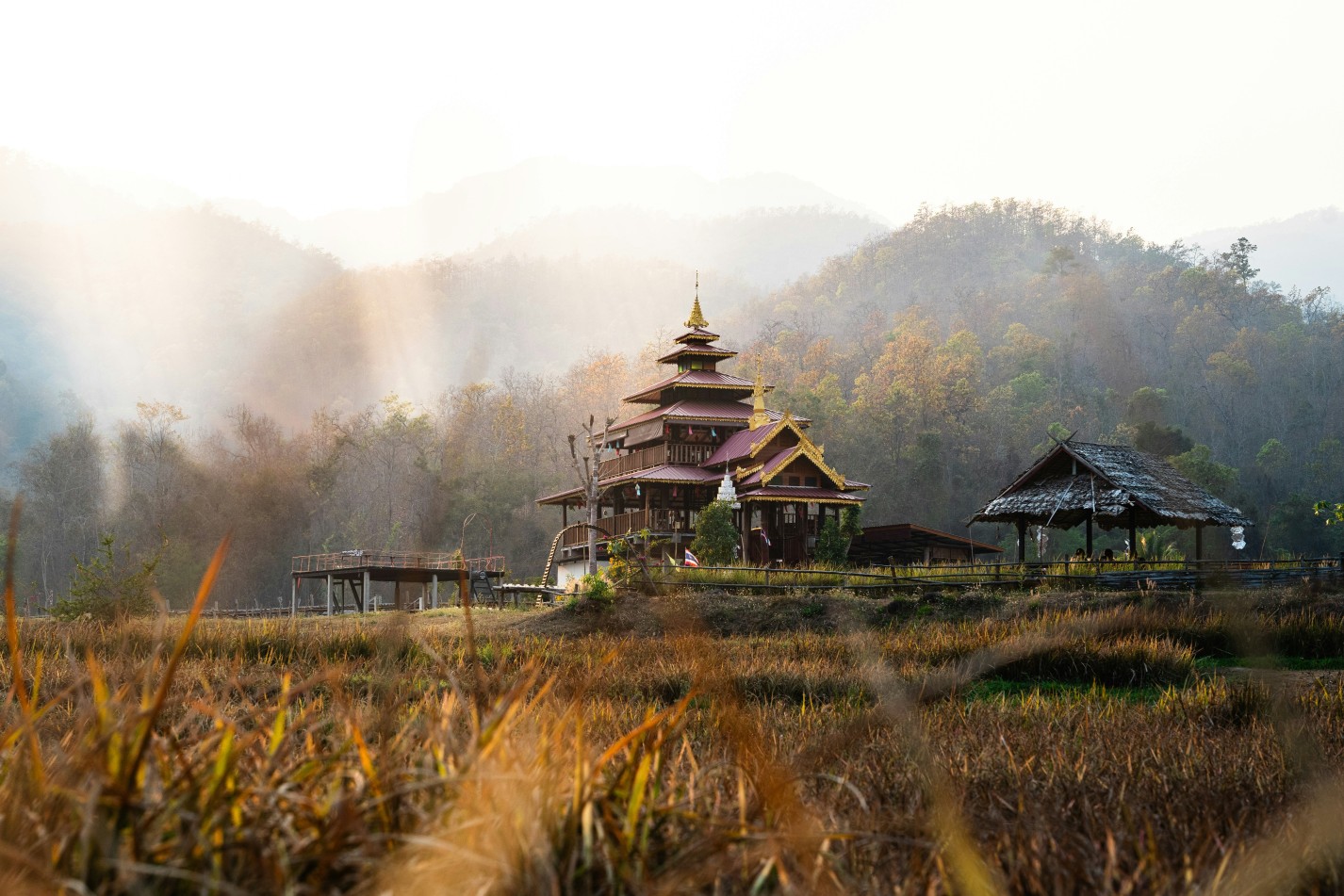 Scenic Thai temple in northern Thailand at sunrise, nestled in peaceful countryside a hidden cultural gem beyond Bangkok.