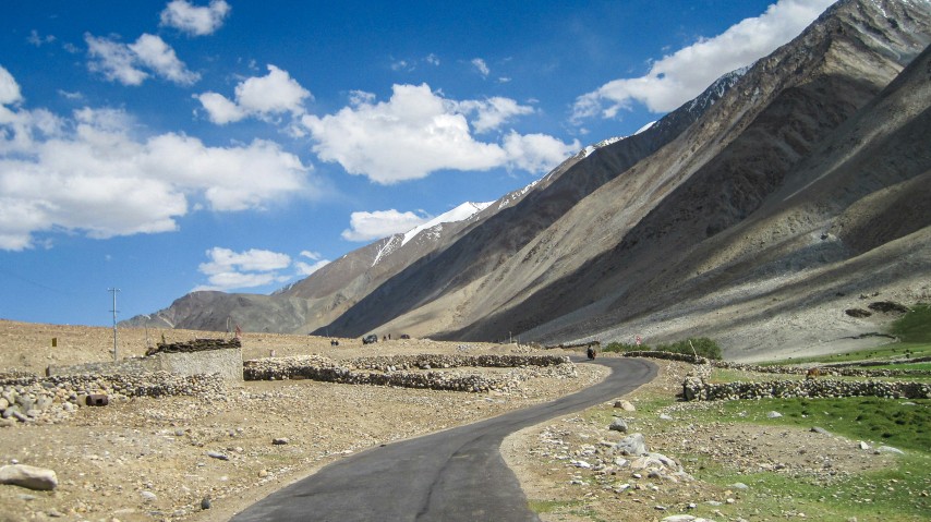 Ladakh road trip scene with dramatic mountain backdrop.