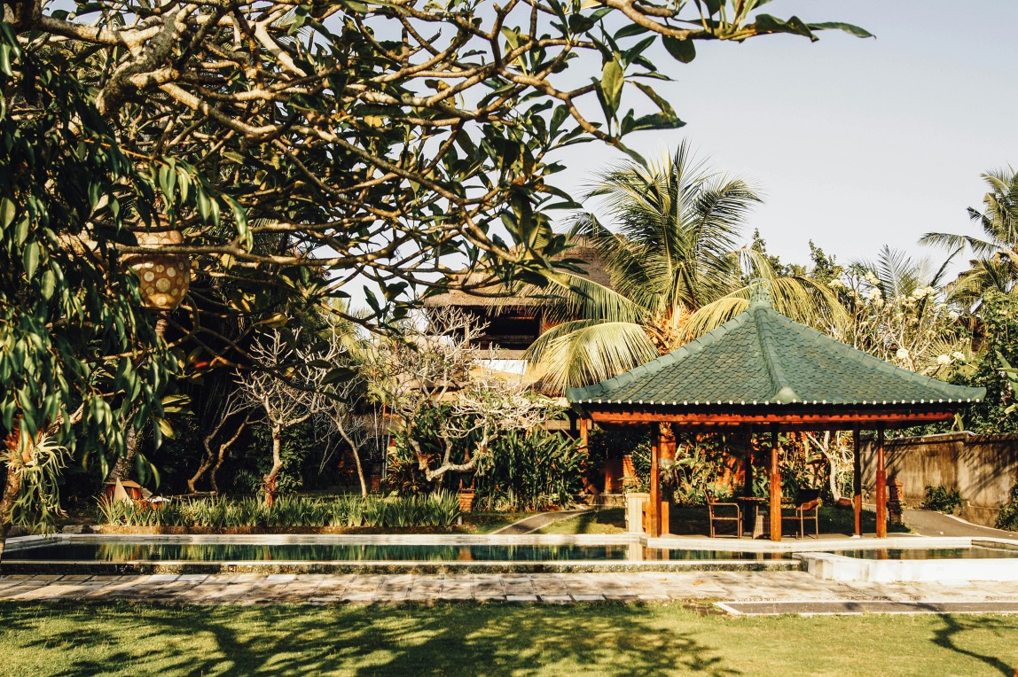 Serene garden pavilion and lush tropical surroundings at Carnoustie Ayurveda & Wellness Resort in Mararikulam, offering a tranquil space for relaxation and holistic healing.