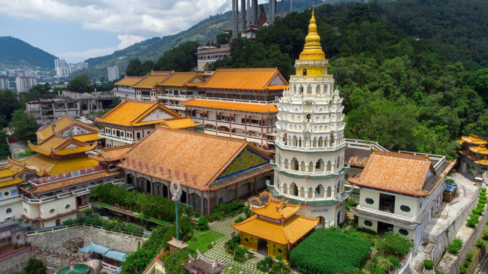 Colorful heritage buildings and street art in George Town, Penang, with a bustling local street scene and vibrant cultural charm