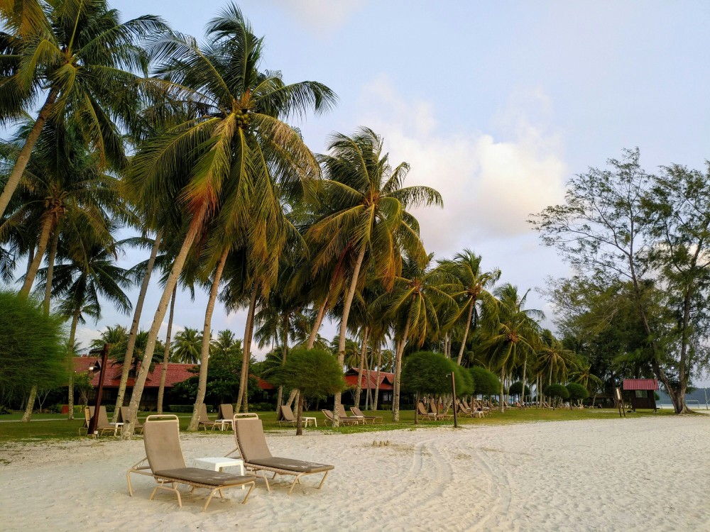 Serene white-sand beach in Malaysia, perfect for a romantic getaway or nature escape