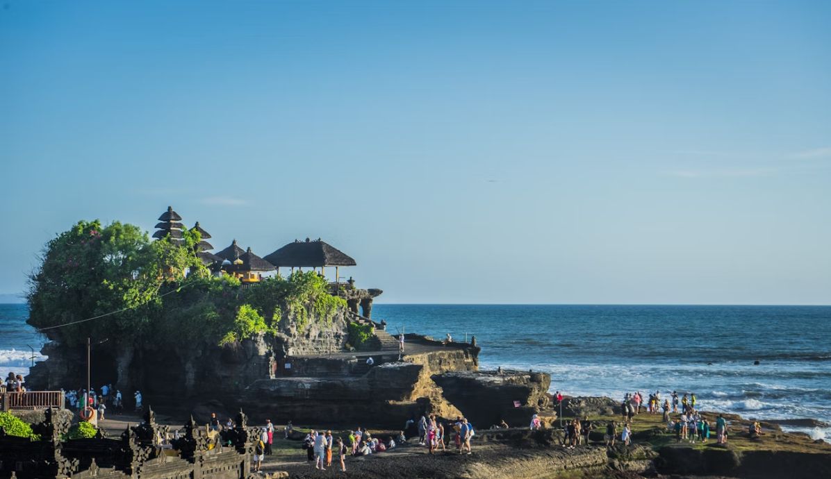Tanah Lot Temple in Bali at sunset, a famous cultural and spiritual landmark by the sea.