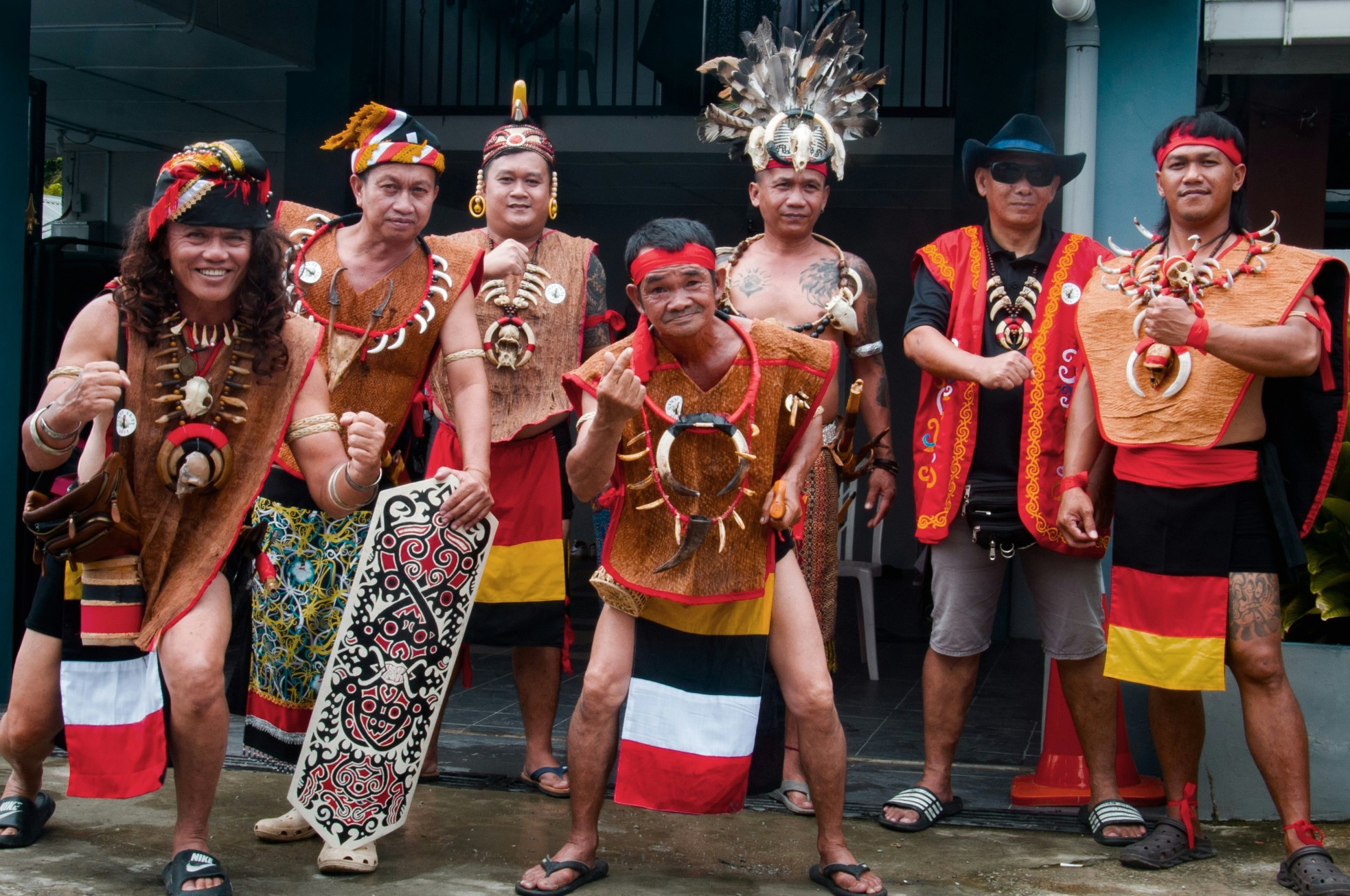 Group of men in traditional Dayak attire during a cultural celebration in Malaysia