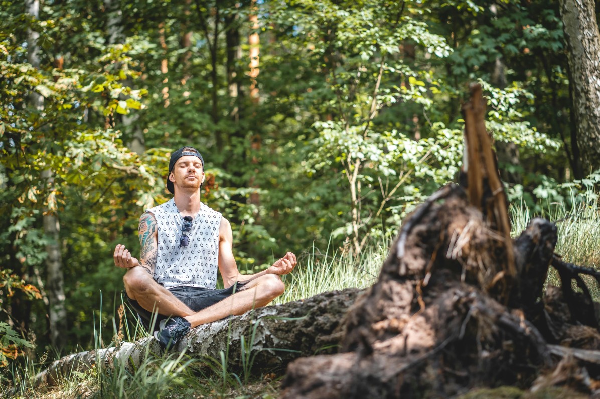 traveler doing meditation in the forest