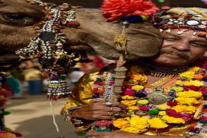 man with his decorated camel at the annual mela (fair) that takes place in Pushkar, Rajasthan.