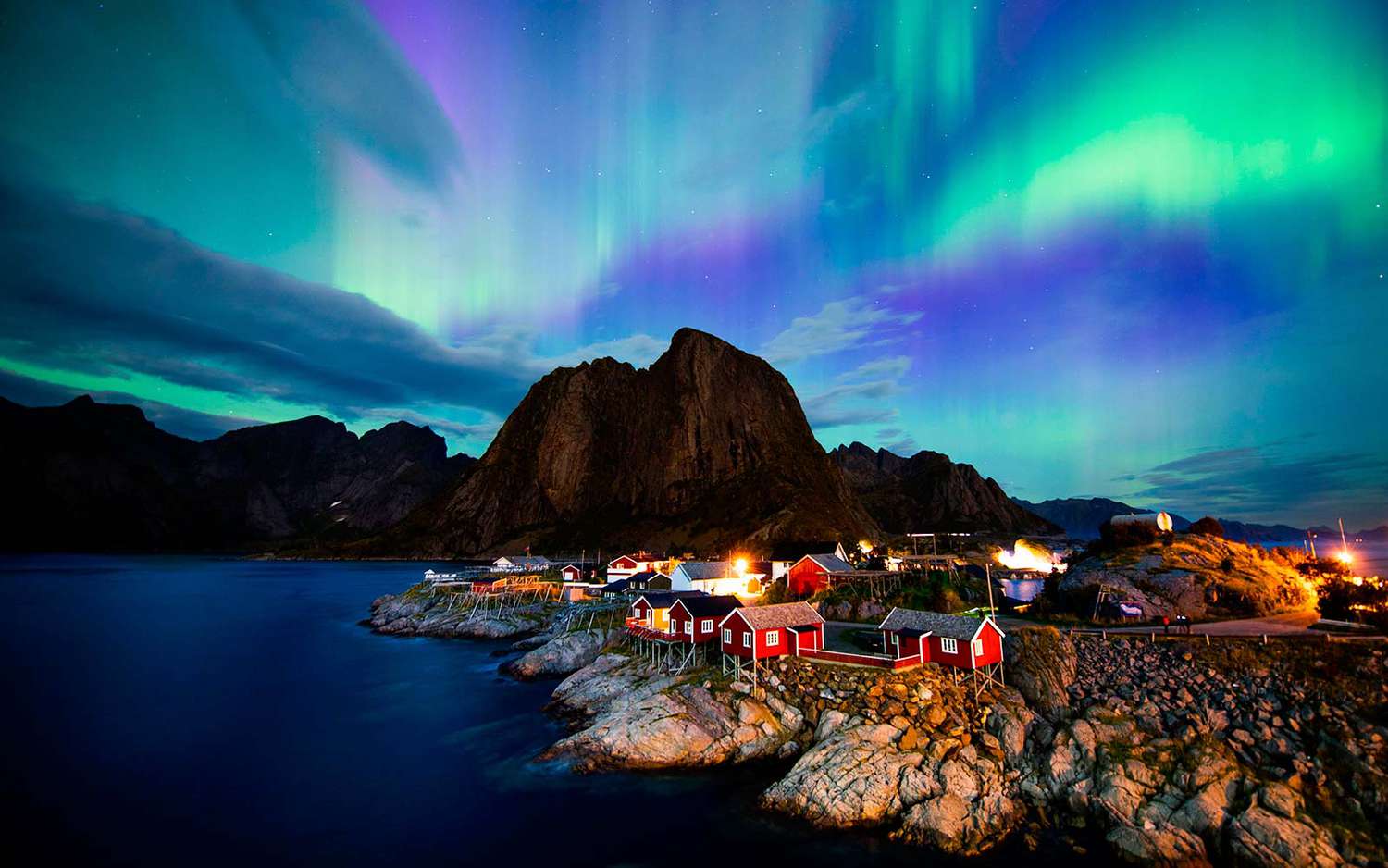 Northern Lights illuminating the fjords and snow-covered landscapes of Tromsø, Norway