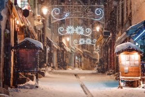 Winter magic christmas decorated european street with blurred snowflakes